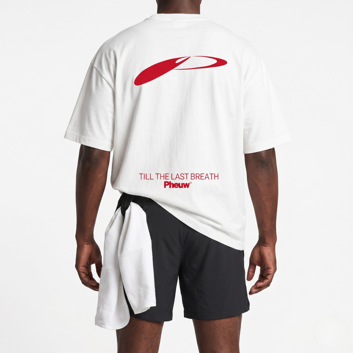 Back view of a runner in black Aero-Strike Shorts and a white Pheuw graphic tee with a towel at the waist